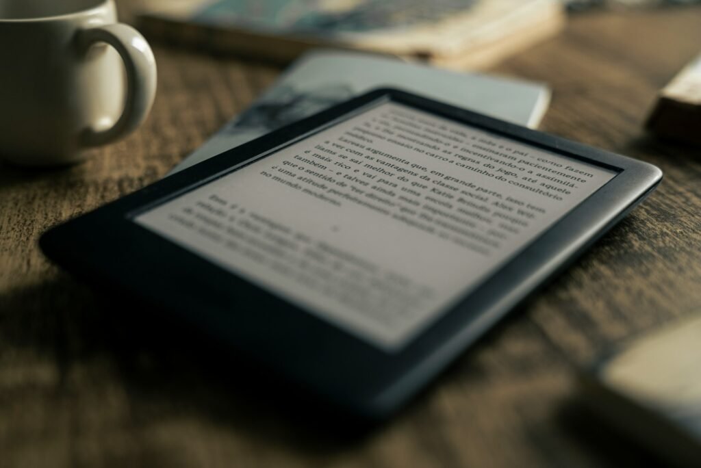 black tablet computer on brown wooden table