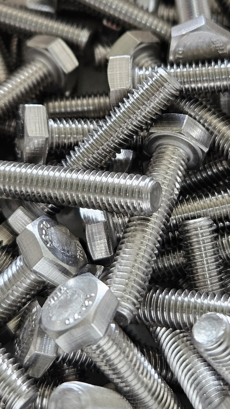 close up of steel hex bolts in bulk